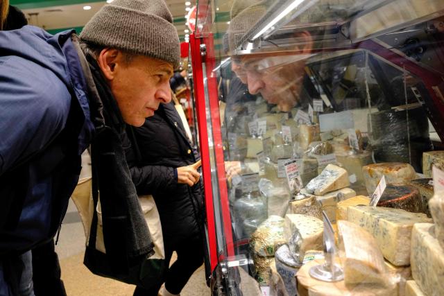 People shop for cheese in a grocery store in the Manhattan borough of New York City on December 13, 2025. (Photo by CHARLY TRIBALLEAU / AFP)