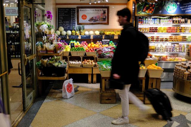 People shop for fruit in a grocery store in the Manhattan borough of New York City on December 13, 2025. (Photo by CHARLY TRIBALLEAU / AFP)