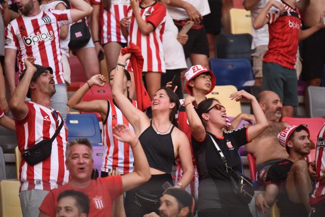 Estudiantes' fans cheer for their team ahead of the Argentine Professional Football League 2025 Clausura Tournament final match between Racing and Estudiantes at the Madre de Ciudades stadium in Santiago del Estero, Argentina on December 13, 2025. (Photo by Luis Santillan / AFP)