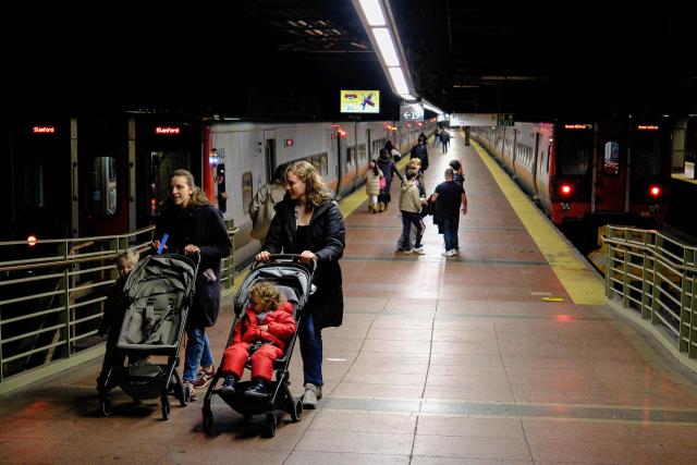 People shop in a liquor store in the Manhattan borough of New York City on December 13, 2025. (Photo by CHARLY TRIBALLEAU / AFP)