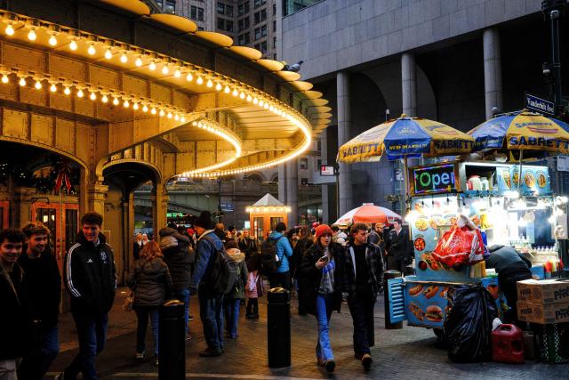 People walk past Grand Central Terminal in the Manhattan borough of New York City on December 13, 2025. (Photo by CHARLY TRIBALLEAU / AFP)