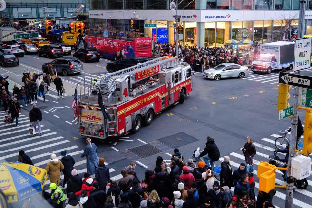 A firefighters’ truck rides along Sixth Avenue and 42nd street in the Manhattan borough of New York City on December 13, 2025. (Photo by CHARLY TRIBALLEAU / AFP)