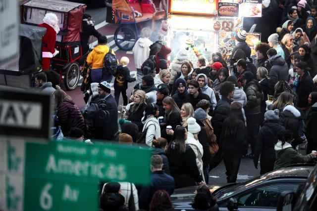 People walk along Sixth Avenue and 42nd street in the Manhattan borough of New York City on December 13, 2025. (Photo by CHARLY TRIBALLEAU / AFP)