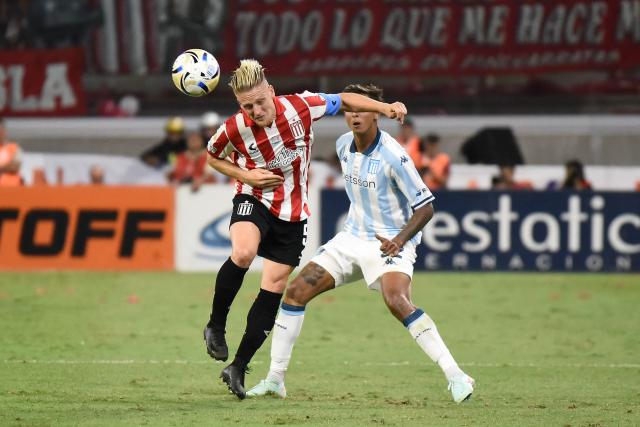 Estudiantes' midfielder #05 Santiago Ascacibar heads the ball next to Racing's midfielder #32 Agustin Almendra during the Argentine Professional Football League 2025 Clausura Tournament final match between Racing and Estudiantes at the Madre de Ciudades stadium in Santiago del Estero, Argentina on December 13, 2025. (Photo by Luis Santillan / AFP)