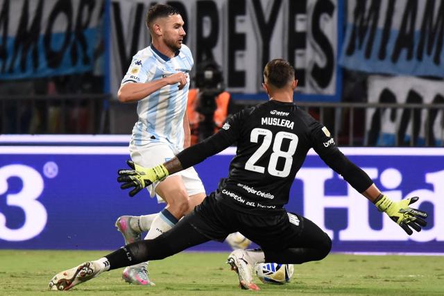 Racing's forward #09 Adrian Martinez and Estudiantes' Uruguayan goalkeeper #28 Fernando Muslera fight for the ball during the Argentine Professional Football League 2025 Clausura Tournament final match between Racing and Estudiantes at the Madre de Ciudades stadium in Santiago del Estero, Argentina on December 13, 2025. (Photo by Luis Santillan / AFP)