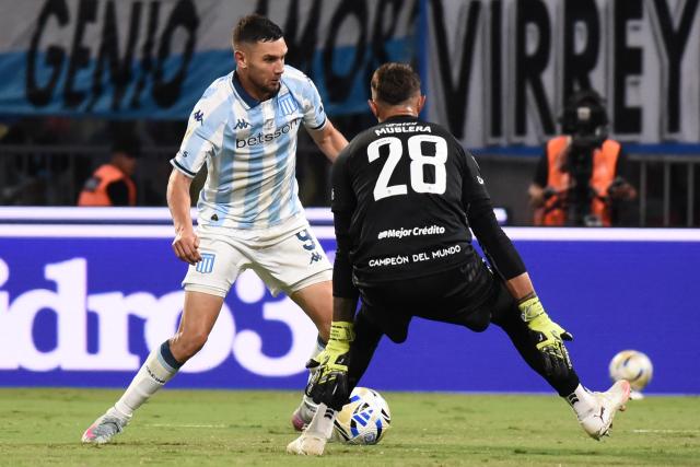 Racing's forward #09 Adrian Martinez and Estudiantes' Uruguayan goalkeeper #28 Fernando Muslera fight for the ball during the Argentine Professional Football League 2025 Clausura Tournament final match between Racing and Estudiantes at the Madre de Ciudades stadium in Santiago del Estero, Argentina on December 13, 2025. (Photo by Luis Santillan / AFP)