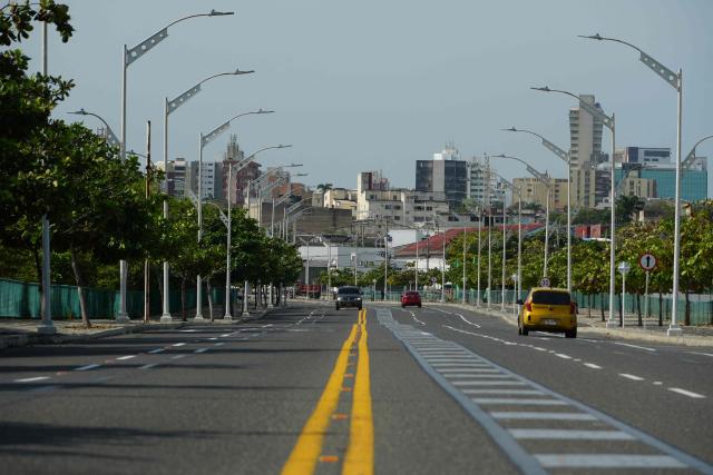 Vehicles transit on a road in Barranquilla, Atlantico Department, Colombia on December 13, 2025. Formula 1 officials recently visited Barranquilla, Colombia, with a view to creating a Grand Prix in this Caribbean city, the mayor announced on December 12, 2025. (Photo by Vanessa ROMERO / AFP)