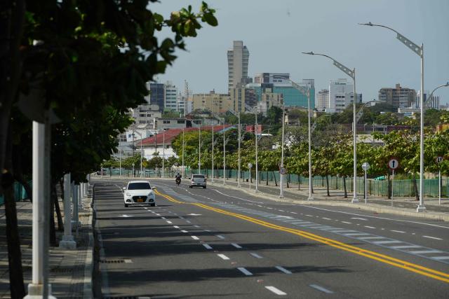 Vehicles transit on a road in Barranquilla, Atlantico Department, Colombia on December 13, 2025. Formula 1 officials recently visited Barranquilla, Colombia, with a view to creating a Grand Prix in this Caribbean city, the mayor announced on December 12, 2025. (Photo by Vanessa ROMERO / AFP)