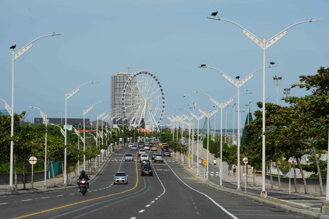 Vehicles transit on a road in Barranquilla, Atlantico Department, Colombia on December 13, 2025. Formula 1 officials recently visited Barranquilla, Colombia, with a view to creating a Grand Prix in this Caribbean city, the mayor announced on December 12, 2025. (Photo by Vanessa ROMERO / AFP)