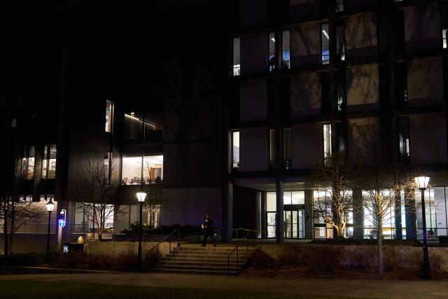 A Brown University police officer cordons off access to the Barus & Holley engineering building at Brown University campus in Providence, Rhode Island, on December 13, 2025. A gunman killed two people and critically wounded eight others in the afternoon of December 13 at prestigious Brown University, authorities said, urging people in the area to remain in lockdown as the attacker was still at large. (Photo by Bing Guan / AFP)