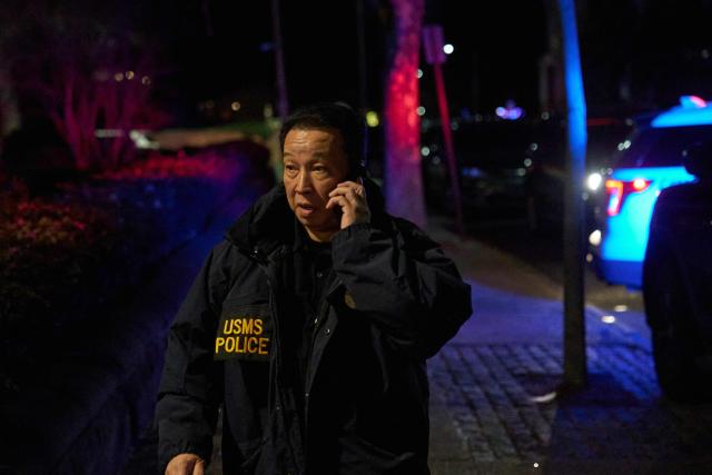 A US Marshalls officer arrives to the Barus & Holley engineering building at Brown University campus in Providence, Rhode Island, on December 13, 2025. A gunman killed two people and critically wounded eight others in the afternoon of December 13 at prestigious Brown University, authorities said, urging people in the area to remain in lockdown as the attacker was still at large. (Photo by Bing Guan / AFP)