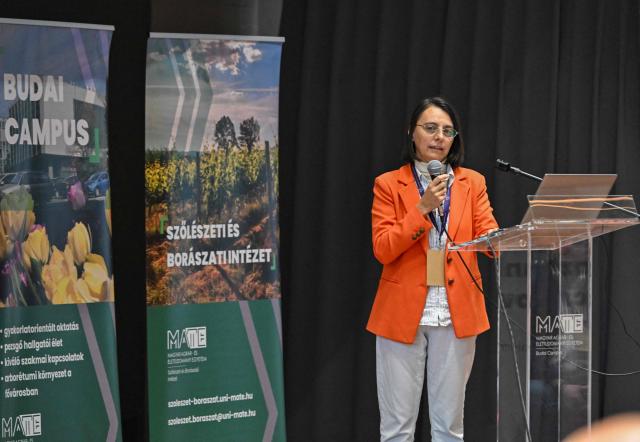 Elisa Angelini, researcher at the Italian Centre for Research in Viticulture and Enology, gives a presentation about her field of science at the Budai Campus of the Hungarian University of Agriculture and Life Sciences (MATE) in Budapest, Hungary, on November 13, 2025, during the the 7th National Viticulture and Winemaking conference. An outbreak of the flavescence doree disease has ravaged Europe's wine regions, including in Hungary. Flavescence doree (FD) is "one of the most dangerous diseases" threatening vineyards today, according to the International Organisation of Vine and Wine (OIV). Infection -- usually indicated by discoloured leaves -- greatly reduces vine productivity, and there is no known cure, although it is not harmful to humans. FD is transmitted primarily by the American grapevine leafhopper, a pest that has spread significantly across central Europe in recent years. (Photo by Attila KISBENEDEK / AFP)