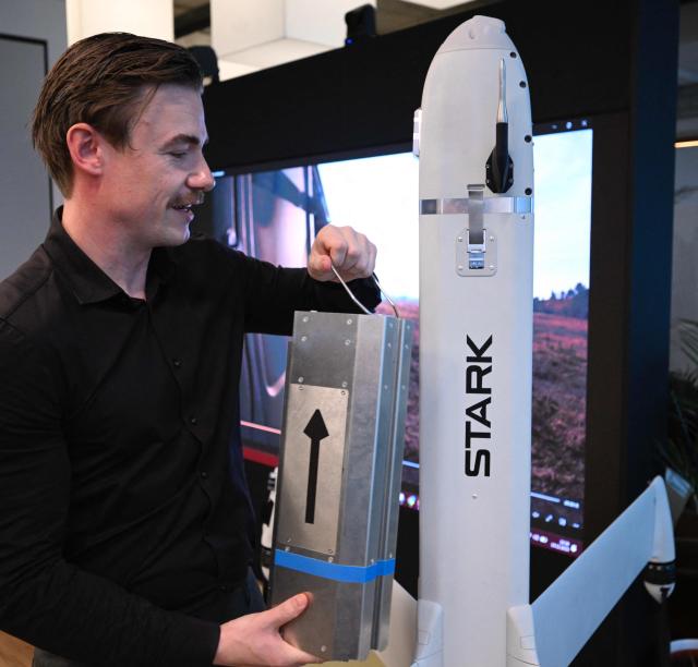 Senior Vice President at German tech defence start-up Stark Josef Kranawetvogl gives explanations on the Virtus strike drone during an AFP interview on December 10, 2025 at the company’s show room in Berlin. Defence giants are drawing battle lines as Germany rearms, with the old guard arguing for a continued focus on traditional heavy weaponry while start-ups push for a shift to more modern kit like AI-enabled drones. (Photo by Tobias SCHWARZ / AFP) / TO GO WITH AFP STORY by Sam Reeves with Femke Colborne