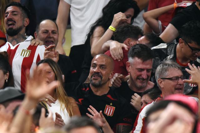 Estudiantes' Argentine president and former player Juan Sebastian Veron (C) celebrates among fans after winning the penalty shootout of the Argentine Professional Football League 2025 Clausura Tournament final match between Racing and Estudiantes at the Madre de Ciudades stadium in Santiago del Estero, Argentina on December 13, 2025. (Photo by Luis Santillan / AFP)