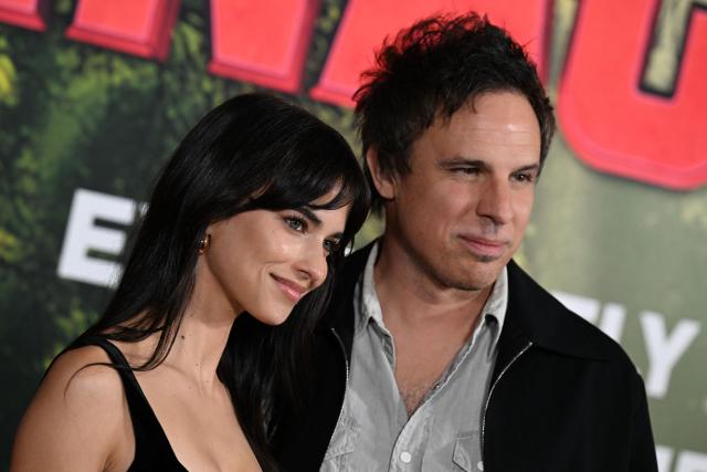 US director Tom Gormican (R) and Australian actress Renee Herbert attend the premiere of Columbia Pictures' "Anaconda" at The United Theater on Broadway in Los Angeles, California, on December 13, 2025. (Photo by Robyn Beck / AFP)
