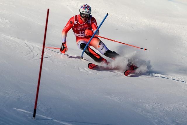 Switzerland's Daniel Yule competes during the first run of the Men's Slalom event of the FIS Alpine Skiing World Cup in Val d'Isere, on December 14, 2025. (Photo by Olivier CHASSIGNOLE / AFP)