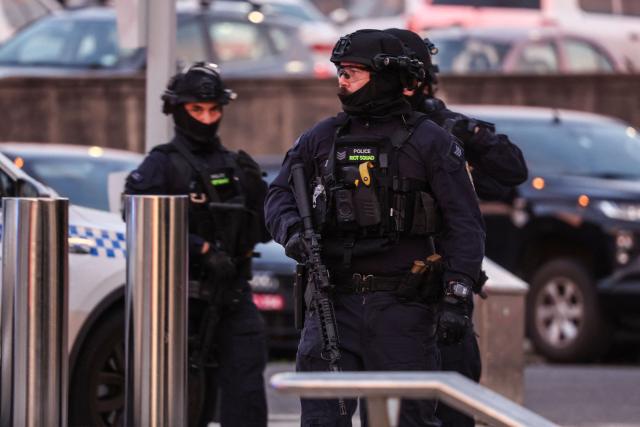 Armed police work at the scene after a shooting incident at Bondi Beach in Sydney on December 14, 2025. Australian police said two people were in custody following reports of multiple gunshots on December 14 at Sydney's famed Bondi Beach, urging the public to take shelter. (Photo by DAVID GRAY / AFP)