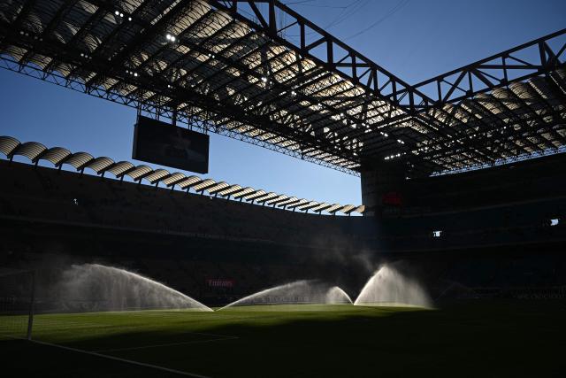 Sprinklers spray water on the pitch ahead of the Italian Serie A football match between AC Milan and Sassuolo at the San Siro Stadium in Milan, Italy on December 14, 2025 (Photo by Piero CRUCIATTI / AFP)