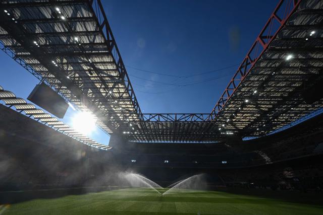 Sprinklers spray water on the pitch ahead of the Italian Serie A football match between AC Milan and Sassuolo at the San Siro Stadium in Milan, Italy on December 14, 2025 (Photo by Piero CRUCIATTI / AFP)