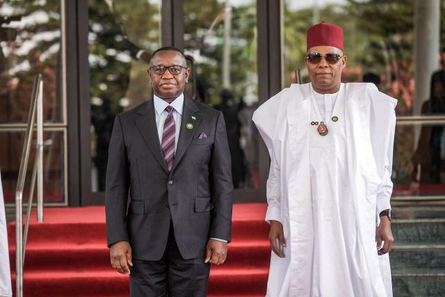 Vice President of Nigeria Kashim Shettima (R) welcomes the President of the Sierra Leone, Julius Maada Bio (L), at the Presidential Villa during the 68th Ordinary Session of the Authority of Heads of State and Government of the Economic Community of West African States (ECOWAS) in Abuja on December 14, 2025. (Photo by Light Oriye Tamunotonye / AFP)