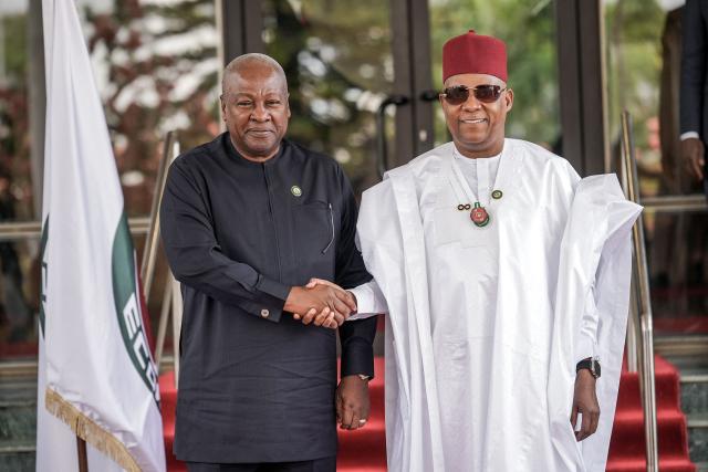 Vice President of Nigeria Kashim Shettima (R) welcomes the President of Ghana, John Dramani Mahama (L), at the Presidential Villa during the 68th Ordinary Session of the Authority of Heads of State and Government of the Economic Community of West African States (ECOWAS) in Abuja on December 14, 2025. (Photo by Light Oriye Tamunotonye / AFP)