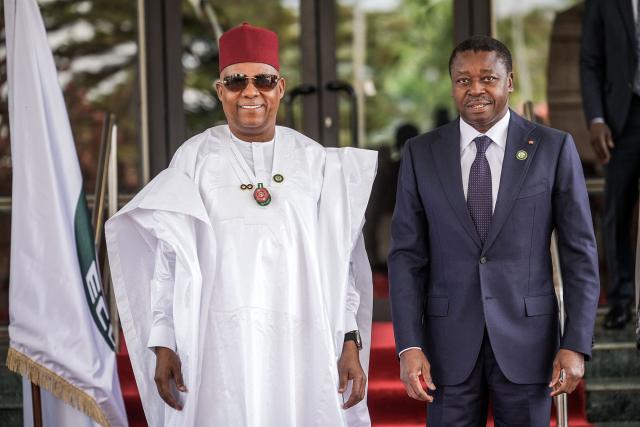 Vice President of Nigeria Kashim Shettima (L) welcomes the President of the Togolese Republic, Faure Essozimna Gnassingbe (R), at the Presidential Villa during the 68th Ordinary Session of the Authority of Heads of State and Government of the Economic Community of West African States (ECOWAS) in Abuja on December 14, 2025. (Photo by Light Oriye Tamunotonye / AFP)