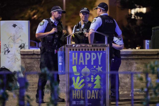 Police work on a street after a shooting incident at Bondi Beach in Sydney on December 14, 2025. Australian police said two people were in custody following reports of multiple gunshots on December 14 at Sydney's famed Bondi Beach, urging the public to take shelter. (Photo by DAVID GRAY / AFP)