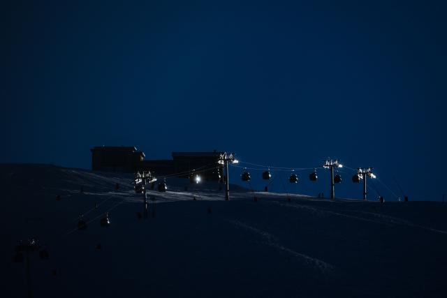 This photograph taken on December 14, 2025 shows ski lifts before sunrise in Val-d’Isere, in the French Alps on December 14,2025. (Photo by OLIVIER CHASSIGNOLE / AFP)