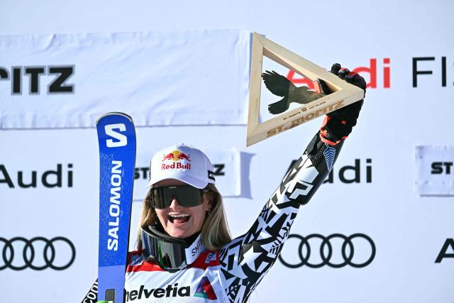 First-placed New Zealand's Alice Robinson celebrates on the podium after the Women's Super G event of the FIS Alpine Skiing World Cup 2025-2026, in St. Moritz, south-eastern Switzerland on December 14, 2025. (Photo by Fabrice COFFRINI / AFP)