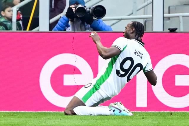Sassuolo's Canadian midfielder #90 Ismaël Koné celebrates after scoring his team's first goal during the Italian Serie A football match between AC Milan and Sassuolo at the San Siro Stadium in Milan, Italy on December 14, 2025 (Photo by Piero CRUCIATTI / AFP)