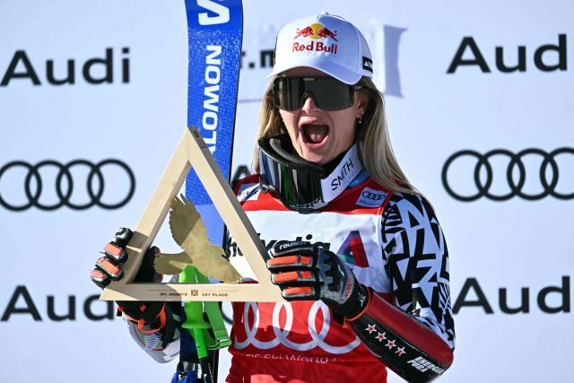 First-placed New Zealand's Alice Robinson celebrates on the podium after the Women's Super G event of the FIS Alpine Skiing World Cup 2025-2026, in St. Moritz, south-eastern Switzerland on December 14, 2025. (Photo by Fabrice COFFRINI / AFP)