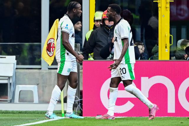 Sassuolo's Canadian midfielder #90 Ismaël Koné (L) celebrates after scoring his team's first goal during the Italian Serie A football match between AC Milan and Sassuolo at the San Siro Stadium in Milan, Italy on December 14, 2025 (Photo by Piero CRUCIATTI / AFP)