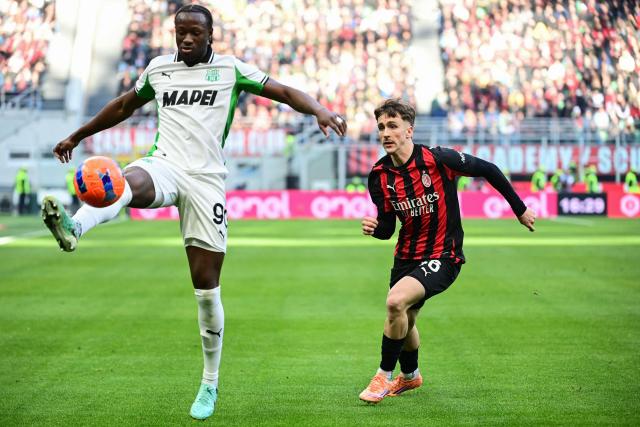 Sassuolo's Canadian midfielder #90 Ismaël Koné controls the ball next to AC Milan's Belgian midfielder #56 Alexis Saelemaekers during the Italian Serie A football match between AC Milan and Sassuolo at the San Siro Stadium in Milan, Italy on December 14, 2025 (Photo by Piero CRUCIATTI / AFP)