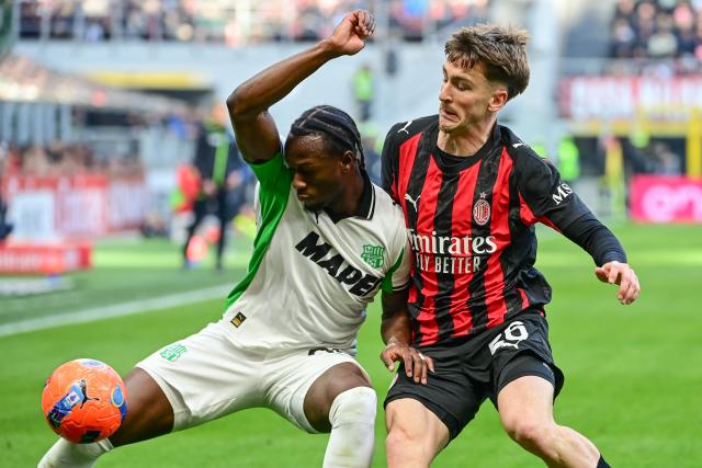 TOPSHOT - Sassuolo's Canadian midfielder #90 Ismaël Koné fights for the ball with AC Milan's Belgian midfielder #56 Alexis Saelemaekers during the Italian Serie A football match between AC Milan and Sassuolo at the San Siro Stadium in Milan, Italy on December 14, 2025 (Photo by Piero CRUCIATTI / AFP)