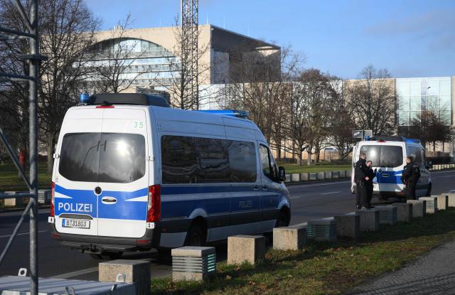 Police stands near the chancellery on December 14, 2025 in Berlin. Ukrainian President Volodymyr Zelensky is set to travel to Berlin and meet European leaders as well as US President Donald Trump's envoy, the heads of the EU and NATO for talks. (Photo by RALF HIRSCHBERGER / AFP)