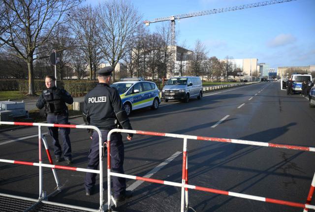 Police stands near the chancellery on December 14, 2025 in Berlin. Ukrainian President Volodymyr Zelensky is set to travel to Berlin and meet European leaders as well as US President Donald Trump's envoy, the heads of the EU and NATO for talks. (Photo by RALF HIRSCHBERGER / AFP)