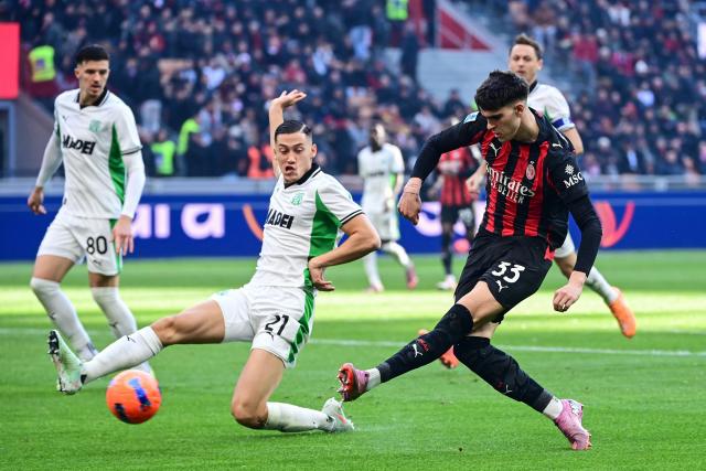 AC Milan's Italian defender #33 Davide Bartesaghi (R) scores his team second goal during the Italian Serie A football match between AC Milan and Sassuolo at the San Siro Stadium in Milan, Italy on December 14, 2025 (Photo by Piero CRUCIATTI / AFP)