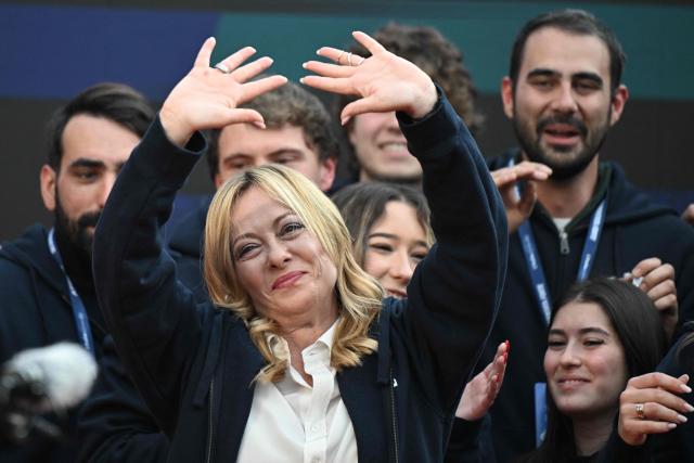 Italy's Prime Minister, Giorgia Meloni greets supporters on stage during the Atreju political meeting organised by the young militants of Italian right wing party Brothers of Italy (Fratelli d'Italia) on December 14, 2025 in Rome. (Photo by Tiziana FABI / AFP)
