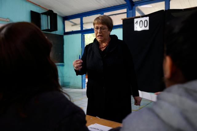 Chile's former president (2006-2010 and 2014-2018) Michelle Bachelet prepares to cast her vote during the presidential runoff election in Santiago on December 14, 2025. Chileans head to the polls for a presidential runoff between Jeannette Jara, a communist backed by a broad left coalition, and Jose Antonio Kast, a devout far-right politico promising a hard line on security and migration. (Photo by Raul BRAVO / AFP)