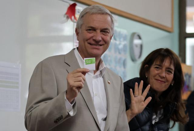 Chile's presidential candidate Jose Antonio Kast, of the Partido Republicano party, poses for a picture with his wife Maria Pia Adriasola before casting his ballot during the presidential runoff election in Paine, south of Santiago, on December 14, 2025. Chileans head to the polls for a presidential runoff between Jeannette Jara, a communist backed by a broad left coalition, and Jose Antonio Kast, a devout far-right politico promising a hard line on security and migration. (Photo by Javier TORRES / AFP)