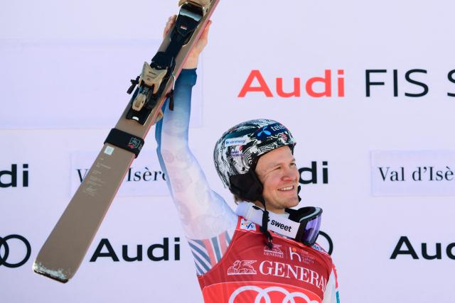 Norway's Timon Haugan celebrates his victory on the podium after winning the second run of the Men's Slalom event of the FIS Alpine Skiing World Cup in Val d'Isere, on December 14, 2025. (Photo by Olivier CHASSIGNOLE / AFP)