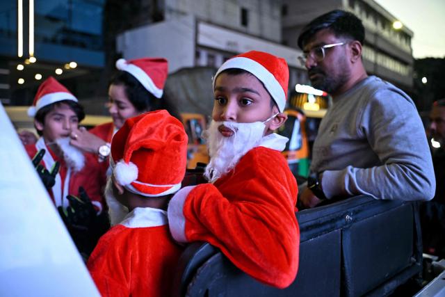 Children dressed as Santa Claus take part in the 'Santa Ride and Drive' rally to raise funds for the education of children with special needs in Bengaluru on December 14, 2025. (Photo by Idrees MOHAMMED / AFP)
