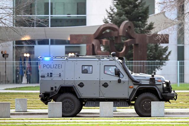 An armoured Police vehicle is parked in front of the chancellery on December 14, 2025 in Berlin. Ukrainian President Volodymyr Zelensky travelled to Berlin to meet European leaders as well as US President Donald Trump's envoy, the heads of the EU and NATO for talks. (Photo by RALF HIRSCHBERGER / AFP)