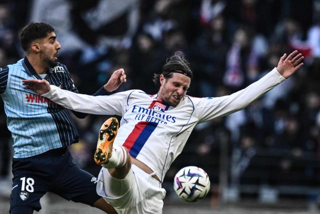 Lyon's Dutch defender #33 Hans Hateboer (R) fights for the ball with Le Havre's French defender #18 Yanis Zouaoui during the French L1 football match between Olympique Lyonnais (OL) and Le Havre AC at the Groupama Stadium in Decines-Charpieu, central-eastern France, on December 14, 2025. (Photo by JEFF PACHOUD / AFP)