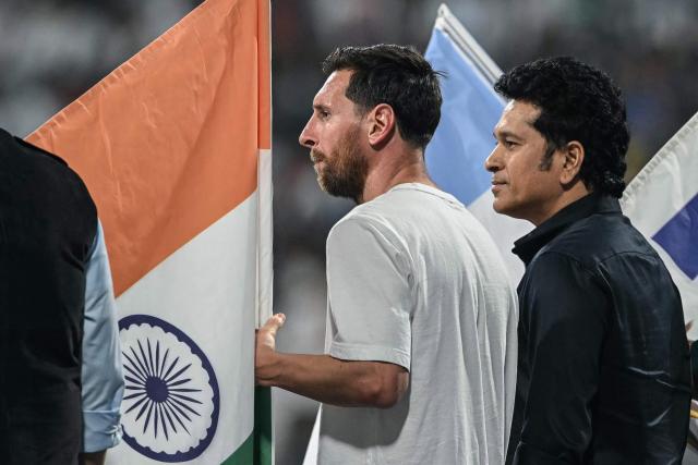 Argentina's footballer Lionel Messi (L) and India's former cricketer Sachin Tendulkar attend an event during Messi's GOAT Tour at the Wankhede Stadium in Mumbai on December 14, 2025. (Photo by Indranil MUKHERJEE / AFP)