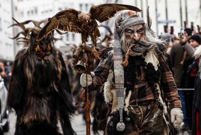 People dressed as "Krampus", a half-goat, half-demon figure "punishing misbehaving children during the Christmas season", take part in the traditional Krampus parade in downtown Munich, Bavaria, southern Germany, on December 14, 2025.  (Photo by Michaela STACHE / AFP)