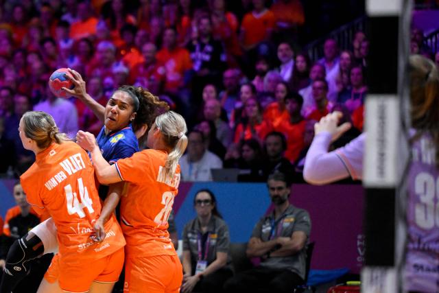 France's left wing #98 Suzanne Wajoka (2nd L) shoots the ball during the IHF Women's Handball World Championship match for 3rd place between the Netherlands and France at the Rotterdam Ahoy Arena, in Rotterdam on December 14, 2025. (Photo by JOHN THYS / AFP)