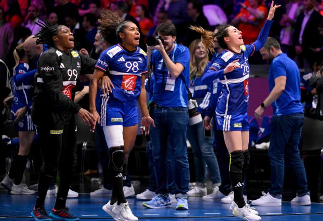 (From L) France's goalkeeper #99 Hatadou Sako, France's left wing #98 Suzanne Wajoka and France's right wing #28 Lucie Granier celebrate after winning the IHF Women's Handball World Championship match for 3rd place between the Netherlands and France at the Rotterdam Ahoy Arena, in Rotterdam on December 14, 2025. (Photo by JOHN THYS / AFP)