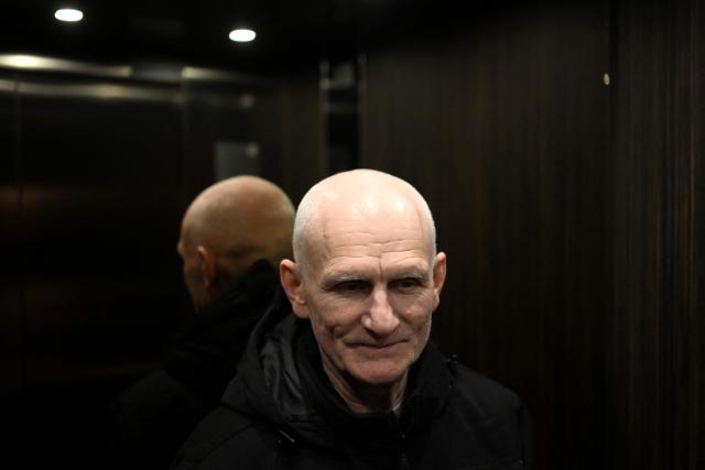 Nobel Peace Prize 2022 laureate Ales Bialiatski rides an elevator at a hotel in Vilnius on December 14, 2025, a day after his release from prison. Belarus has freed 123 prisoners, including protest leaders Viktar Babaryka, Maria Kolesnikova, and Nobel Peace Prize laureate Ales Bialiatski, on December 13, 2025, after the US envoy earlier said Washington was lifting sanctions on Belarusian potassium. (Photo by Sergei GAPON / AFP)