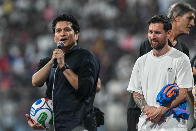 Argentina's footballer Lionel Messi (R) and India's former cricketer Sachin Tendulkar attend an event during Messi's GOAT Tour at the Wankhede Stadium in Mumbai on December 14, 2025. (Photo by Indranil MUKHERJEE / AFP)